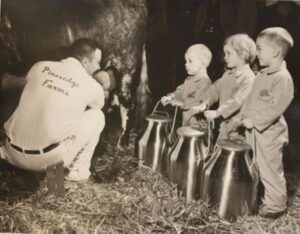 Pictured during early years of the All-American Dairy Show is Sam Yoder with three of his children (L to R) Fred, Nedra and Sam.