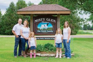 The Pettit family in front of their family farm sign (L-R) Tom, Kris, Madison, Kadie, Suzanne