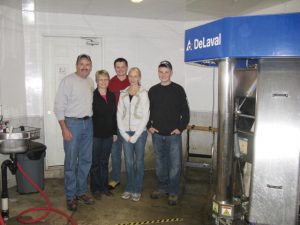 (L-R) Robert, Roberta, Eric, Megan and Owen Wright stand in front of their DeLaval VMS system at Wrico Holsteins.
