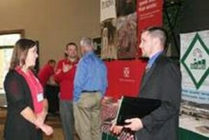 Representatives from agribusinesses that support Dairy Challenge visit with students about career opportunities and industry product and service innovations.